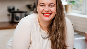 Chelsea Ferdinales, founder of Events By Ferdinales. Smiling and leaning on her elbows