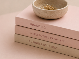 a book stack with three books: 'branding', 'intellectual property' and 'business strategy'