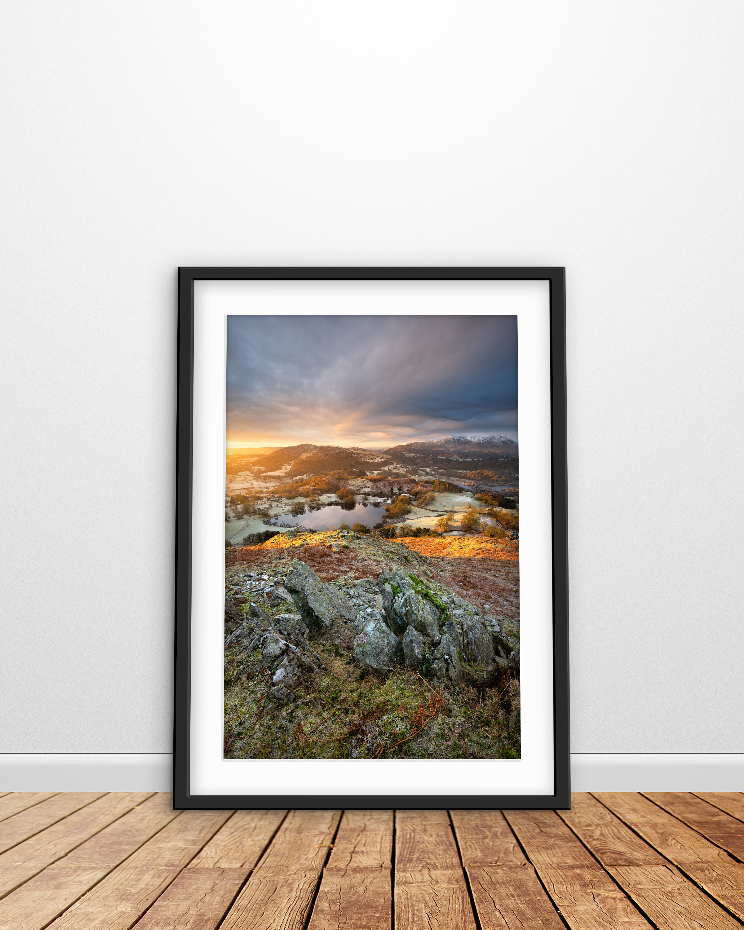 a dramatic view overlooking Loughrigg Tarn and Wetherlam on a frosty morning, seen from Loughrigg Fell in The Lake District,