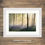 Thumbnail: Framed photography prints of a peaceful bluebell woodland on a misty spring morning with light rays through trees, Dorset, UK