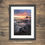 Thumbnail: Framed photography prints of a dramatic sunrise over the coast at Bamburgh Castle in Northumberland, UK.