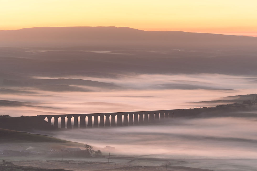 A beautiful misty sunrise over The Ribblehead Viaduct, seen from Whernside in The Yorkshire Dales National Park.