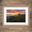 Thumbnail: Framed photography prints of a sunrise and small wooden hut on the beach at Bamburgh Castle, Northumberland, UK.