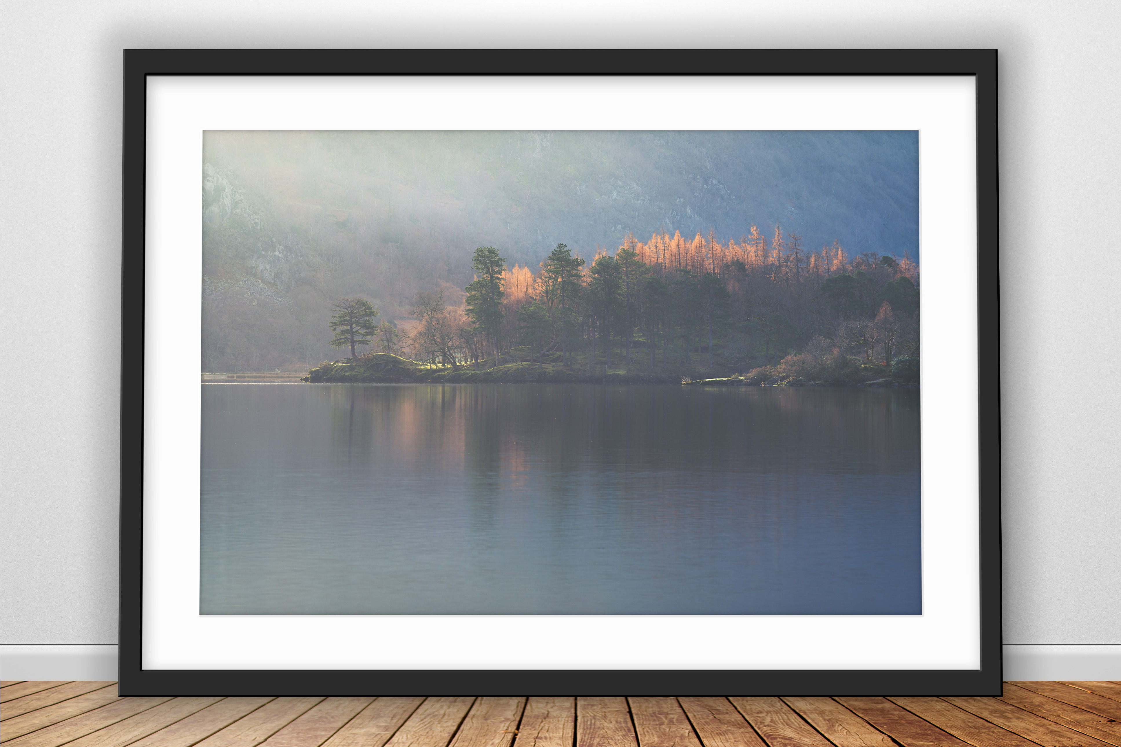 Photography prints of a row of trees on the shoreline of Derwentwater towards Borrowdale catching the golden morning light