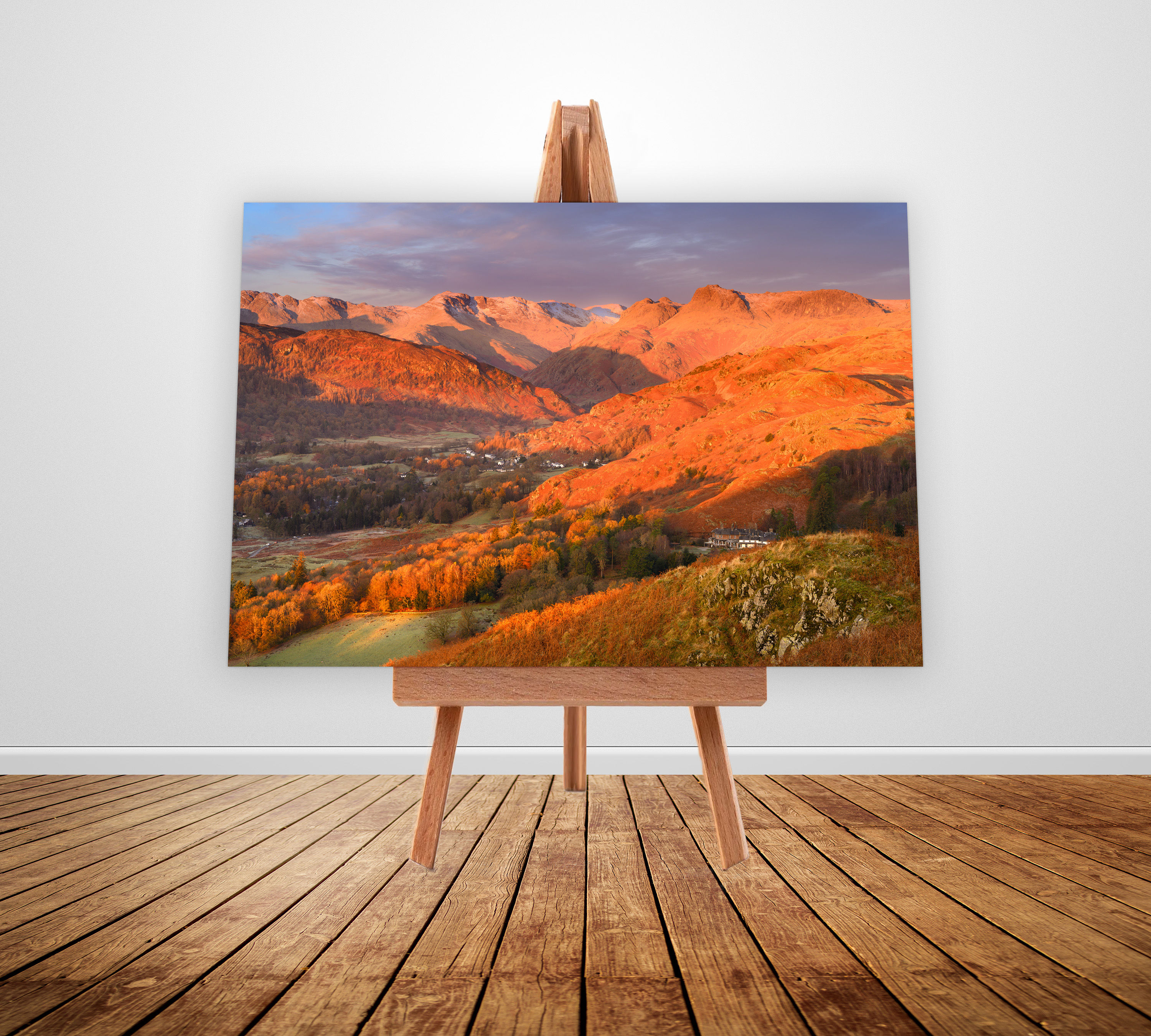 Golden morning light at sunrise on the Langdale Pikes from Loughrigg Fell, overlooking Chapel Stile in The Lake District.
