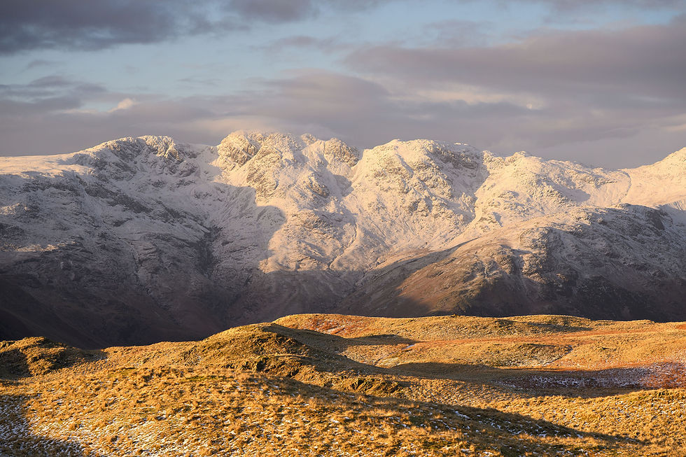 a winter view looking out over Blea Rigg towards a snowcapped Crinkle Crags in The Lake District