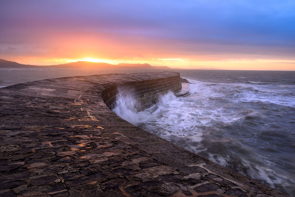 Thumbnail: Photography canvas prints of a dramatic sunrise and crashing waves on The Cobb at Lyme Regis, Dorset, UK.