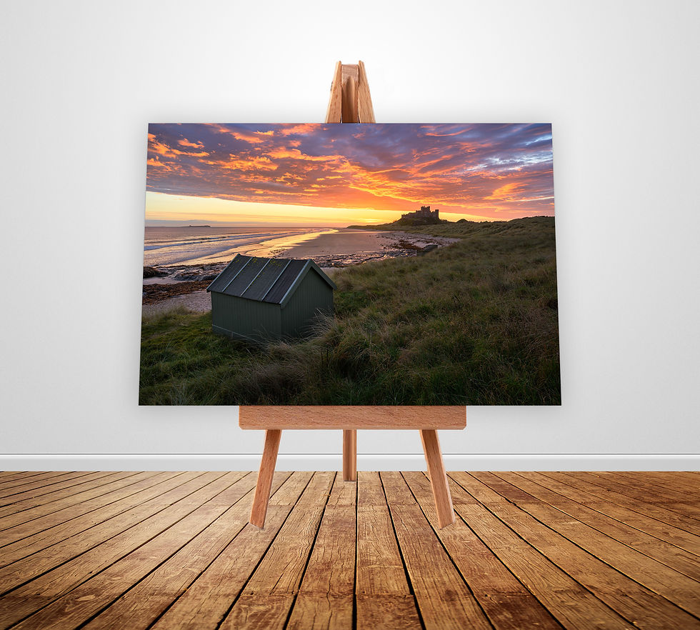 Photography canvas prints of a beautiful view of Bamburgh Castle on The Northumberland Coast with a colourful sunrise