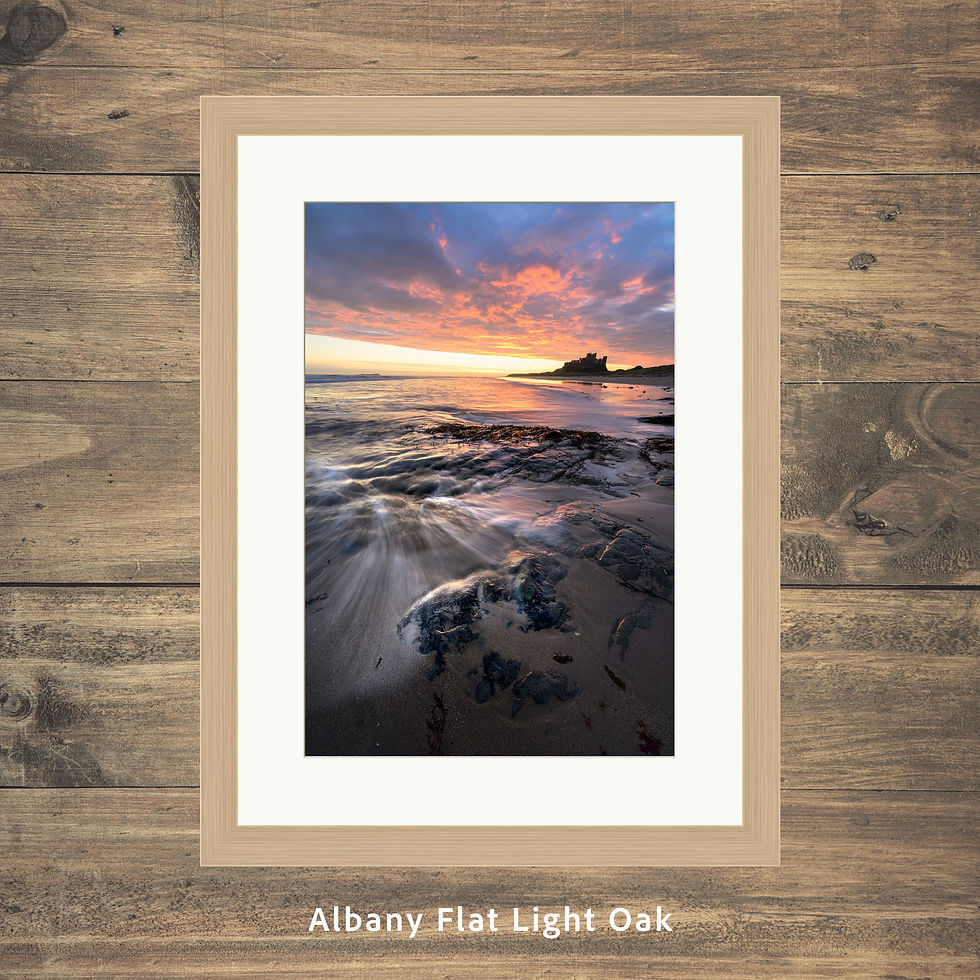 Thumbnail: Framed photography prints of a dramatic sunrise over the coast at Bamburgh Castle in Northumberland, UK.
