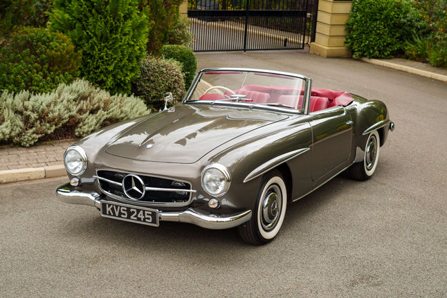 Grey Mercedes-Benz 190 SL parked on the front 3/4 in green space