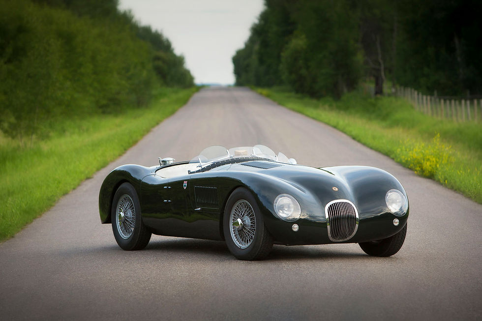 An old sports car parked on a country road.