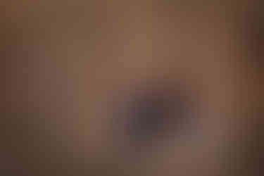 Three girls holding hands and smiling in a forest. Dressed in dark clothes, standing on dry leaves, surrounded by bare trees. Warm lighting. Viewpoint Photography Edmonton