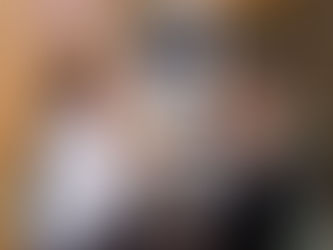 A medical professional consulting with a patient in front of a computer.