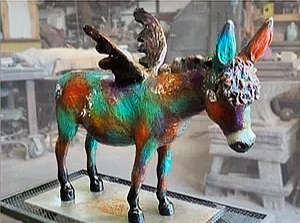 A sculpture of a donkey with angel wings titled "Milagro Grande" in the artist's studio by Barbara Meikle Fine Art