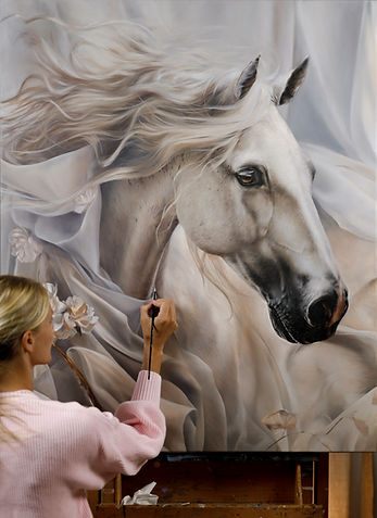 A photograph of Carla Grace painting a large horse portrait titled "Envision" with oil on linen. equustyle.com