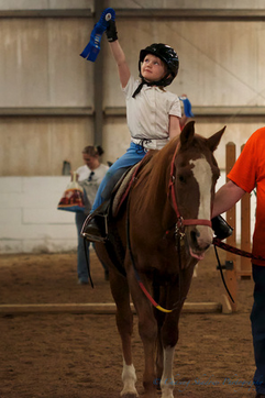 Therapeutic horse with a client enjoying a therapeutic riding lesson at The Right Step, Inc. 
