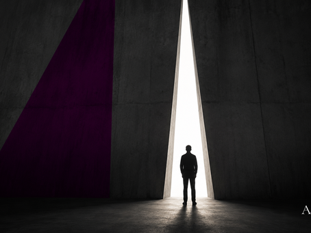 Minimalist architectural scene showing a solitary figure facing a narrow opening of light in a massive concrete wall, symbolizing independent technology validation before major product and development commitments.