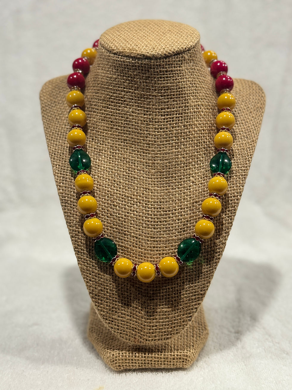 Yellow necklace w/ dark green & a touch of red