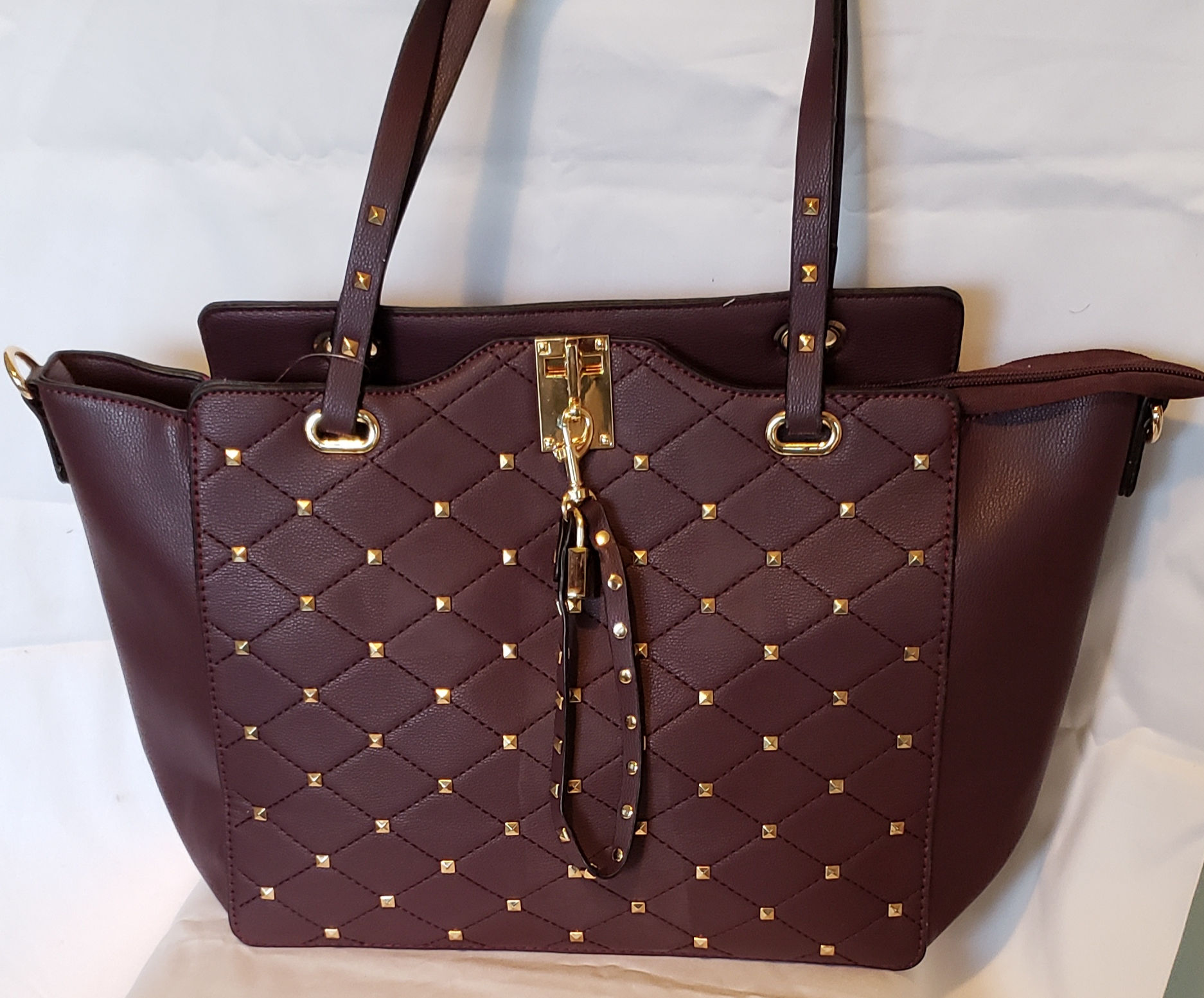 Burgundy handbag with golden details