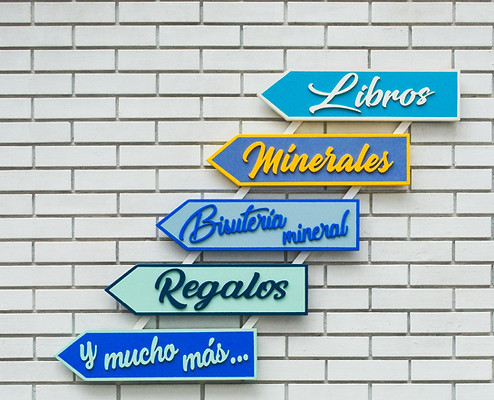 white brick wall with direction-pannels written in Spanish_edited.jpg