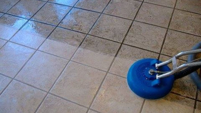 Steam extraction cleaning tile flooring in Tulsa home.