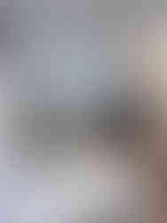 Finished kitchen remodel in North Vancouver featuring white cabinets, wood lower cabinetry, quartz countertops, and modern lighting