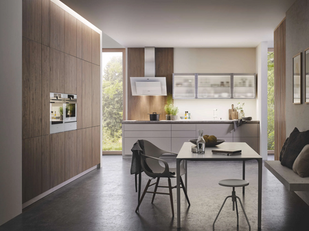 Bauformat modern German kitchen design with wood veneer cabinetry, dark matte base cabinets, integrated appliances, and a contemporary open-concept layout. Image sourced from Bauformat’s official website for design inspiration only.