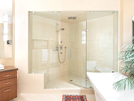 Sleek and modern bathroom featuring a glass shower, bright lighting, and a clean aesthetic with white walls, wood flooring, and minimal decor.