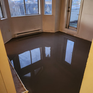 Hastings Sunrise Vancouver condo before renovation living room old flooring fireplace wall original finish