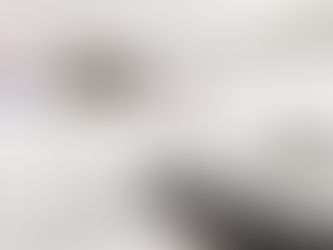 Luxurious bathroom with white bathtub, glass shower, large windows, and potted plant. Bright, airy ambiance with green garden view.