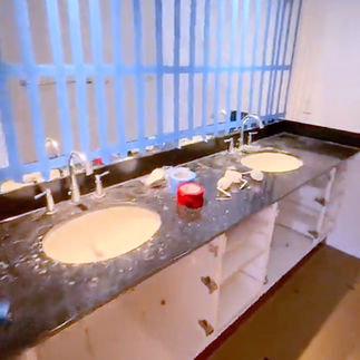 Double sink bathroom vanity renovation with granite countertop and white cabinetry in Vancouver condo bathroom