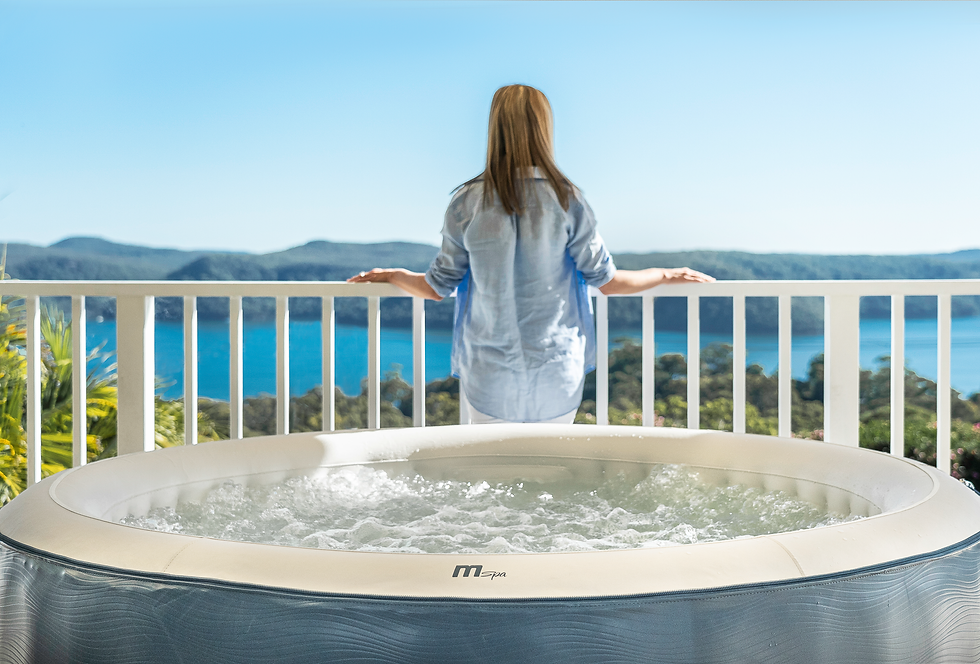 A luxury MSpa inflatable hot tub setup on a backyard patio under a starry night sky.