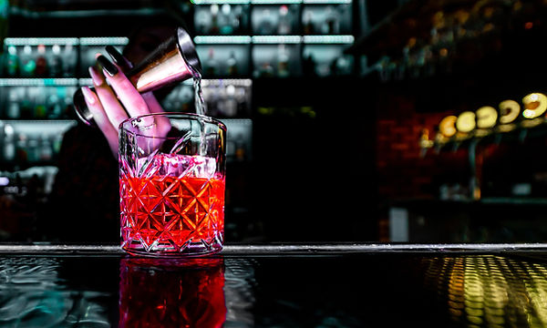 bartender hand making negroni cocktail. Negroni classic cocktail and gin short drink with