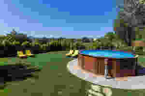 Photo of an above ground pool located in a backyard.