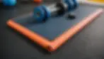 Eye-level view of an exercise mat with fitness equipment for rehabilitation exercises