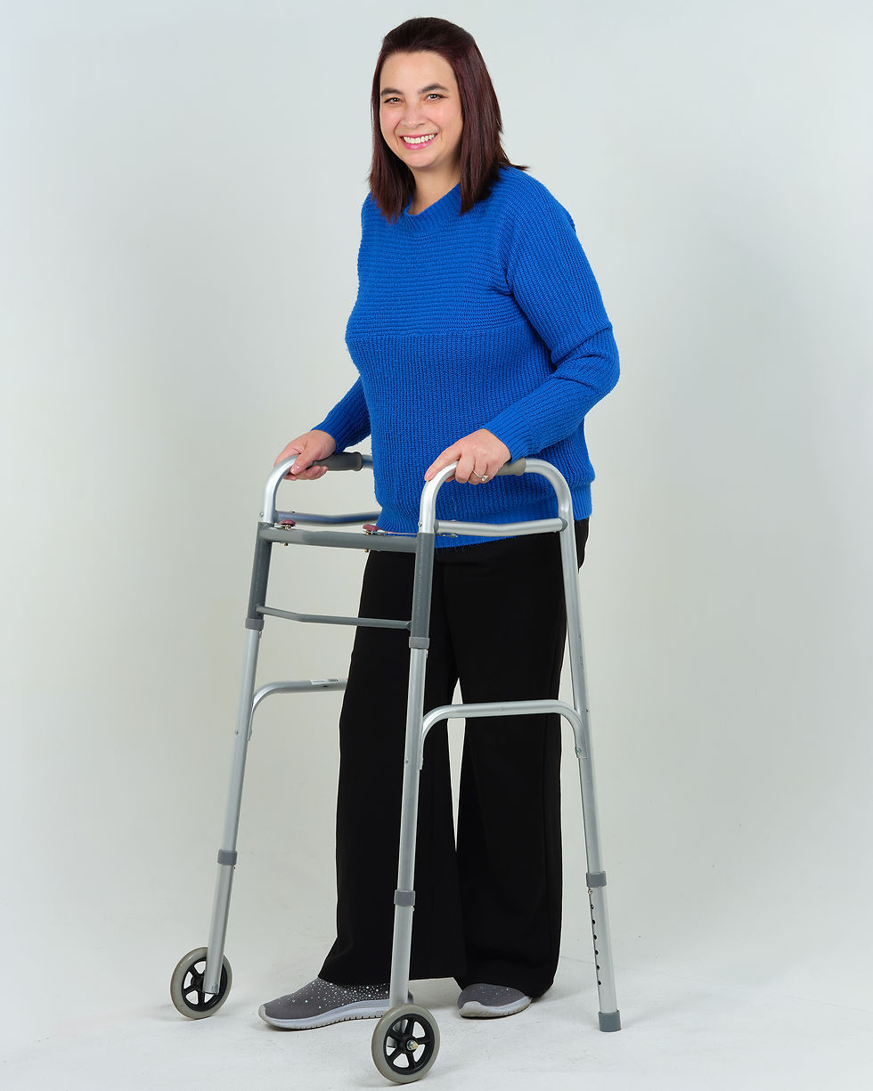 Rachel in a blue sweater using her walker.