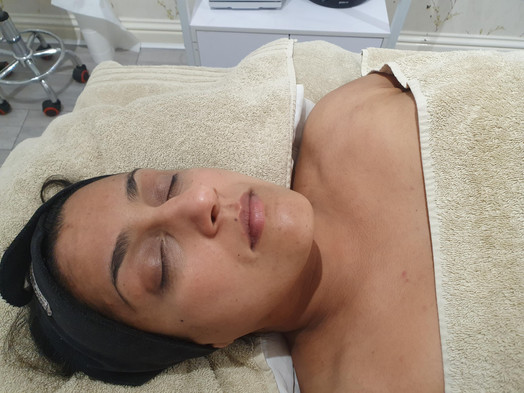 women laying on bed relaxing after beauty treatment