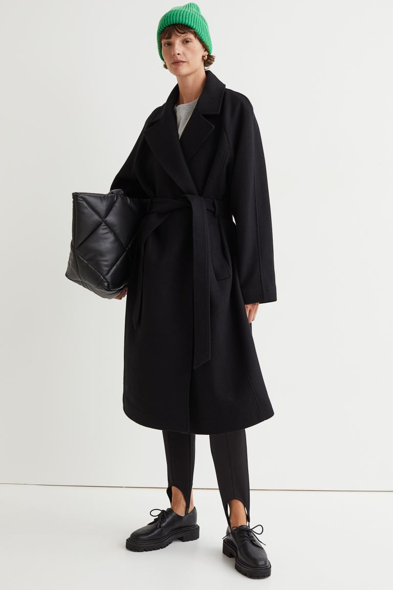 woman wearing a black wrap coat