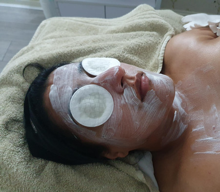 women laying on bed during beauty treatment process