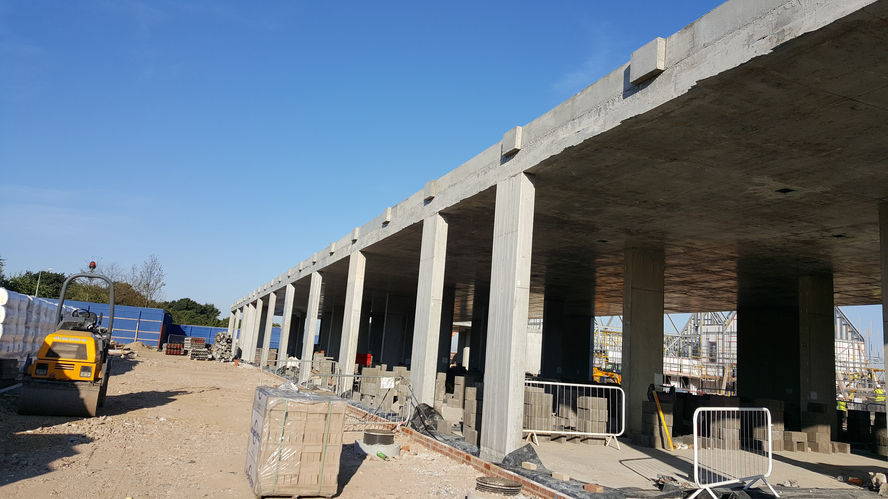 Partially completed concrete structure with multiple support columns and an open construction area