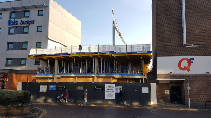 Front view of a modern multi-story building under construction