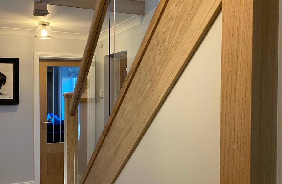 side view of oak staircase with glass balustrades 
