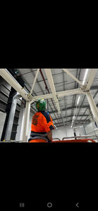 Worker in high-vis vest and helmet on site