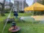 iron pot on fire outside in garden with yellow canopy