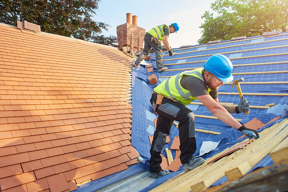 workers on roof installing roof tiles