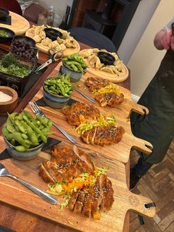 Grilled chicken and edamame on wooden serving boards