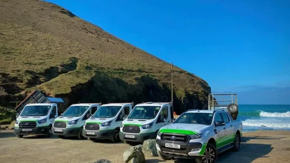 Waste clearance vehicles parked on hillside