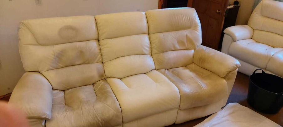dirty three-seat beige leather sofa
