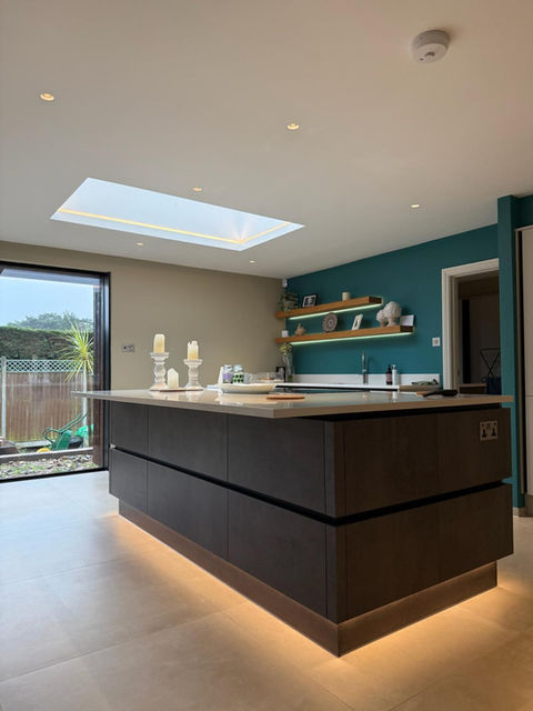Modern kitchen with dark island and skylight