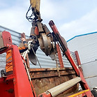 scrap metal skip being unloaded